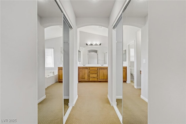 10015 Willowbrook Pond Rd, Las Vegas, NV 89148 - corridor featuring light colored carpet and arched walkways