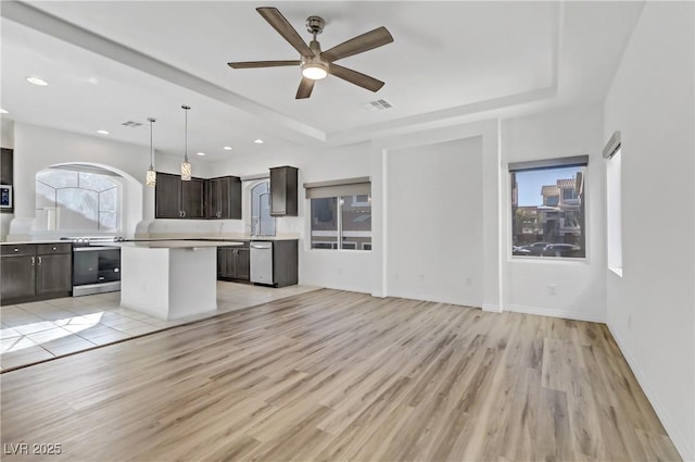 7075 Jasper Hill Way, Las Vegas, NV 89118 - kitchen featuring stainless steel appliances, light countertops, dark brown cabinets, a kitchen island, and a ceiling fan