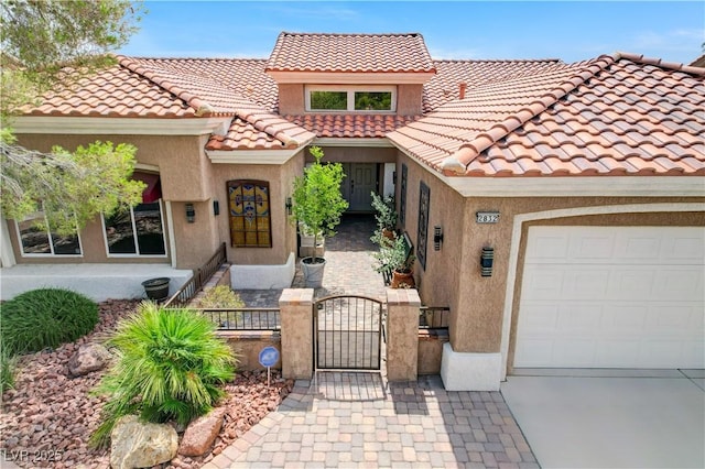 2832 Castle Bar Dr, Las Vegas, NV 89134 - mediterranean / spanish house featuring a fenced front yard, an attached garage, stucco siding, and a gate