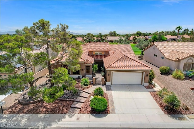 2832 Castle Bar Dr, Las Vegas, NV 89134 - mediterranean / spanish home with stucco siding, a garage, a tile roof, concrete driveway, and a residential view