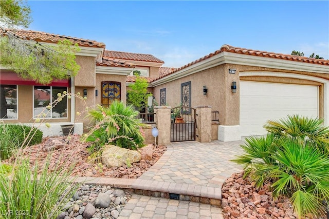 2832 Castle Bar Dr, Las Vegas, NV 89134 - mediterranean / spanish home with an attached garage, a gate, stucco siding, and a tile roof