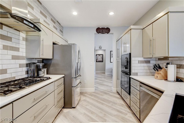 2832 Castle Bar Dr, Las Vegas, NV 89134 - kitchen with stainless steel appliances, exhaust hood, recessed lighting, backsplash, and light wood-type flooring