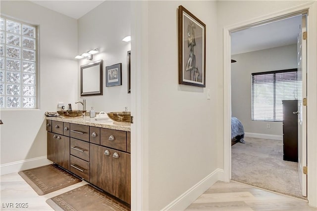 2832 Castle Bar Dr, Las Vegas, NV 89134 - bathroom featuring double vanity and wood finished floors