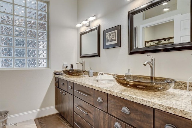 2832 Castle Bar Dr, Las Vegas, NV 89134 - bathroom with baseboards and double vanity