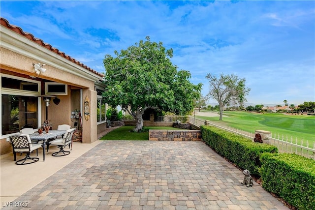 2832 Castle Bar Dr, Las Vegas, NV 89134 - fenced backyard with a patio area, golf course view, and outdoor dining area