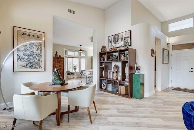 2832 Castle Bar Dr, Las Vegas, NV 89134 - dining space with light wood-style flooring and a towering ceiling