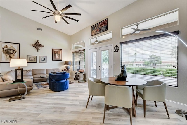 2832 Castle Bar Dr, Las Vegas, NV 89134 - dining area with french doors, a ceiling fan, light wood-style floors, and high vaulted ceiling