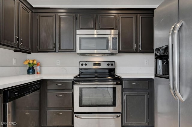 917 Intrigue Way, Las Vegas, NV 89128 - kitchen with appliances with stainless steel finishes, light countertops, and dark brown cabinets
