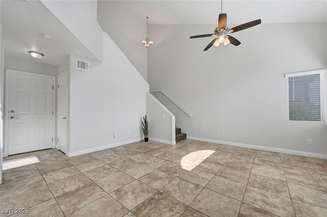 917 Intrigue Way, Las Vegas, NV 89128 - unfurnished living room with a ceiling fan, stairway, and high vaulted ceiling