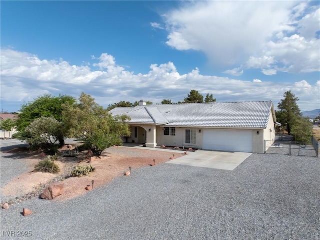 200 E Domingo St, Pahrump, NV 89048 - single story home featuring an attached garage, concrete driveway, a tile roof, and stucco siding