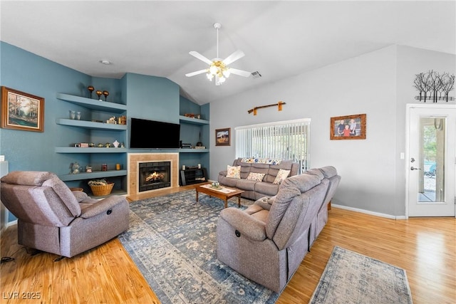 200 E Domingo St, Pahrump, NV 89048 - living area featuring plenty of natural light, wood finished floors, ceiling fan, lofted ceiling, and built in shelves