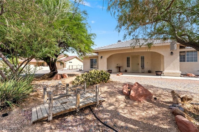 200 E Domingo St, Pahrump, NV 89048 - rear view of house featuring stucco siding and a tiled roof