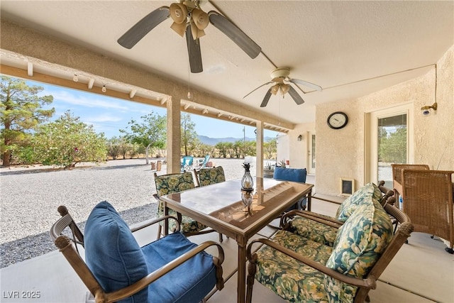 200 E Domingo St, Pahrump, NV 89048 - view of patio / terrace featuring outdoor dining area, a ceiling fan, and a mountain view