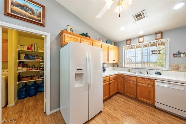 200 E Domingo St, Pahrump, NV 89048 - kitchen with white appliances, vaulted ceiling, light wood-style floors, ceiling fan, and recessed lighting
