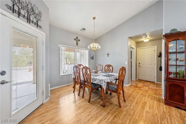 200 E Domingo St, Pahrump, NV 89048 - dining space with a chandelier, light wood finished floors, and high vaulted ceiling