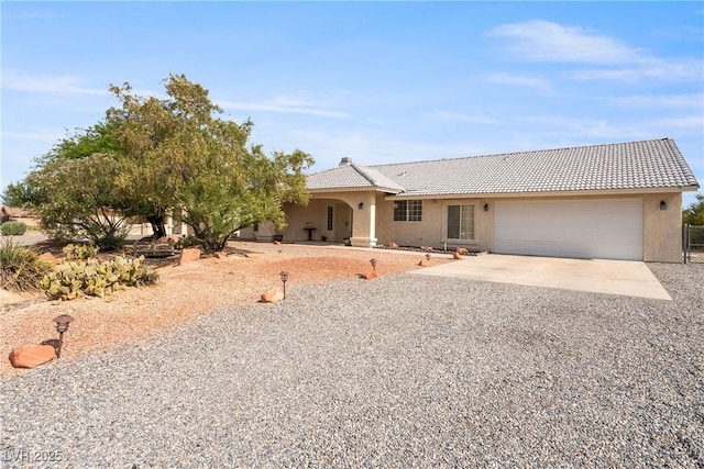 200 E Domingo St, Pahrump, NV 89048 - view of front of property with concrete driveway, a garage, stucco siding, and a tiled roof