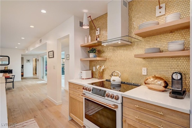 3022 El Camino Ave, Las Vegas, NV 89102 - kitchen featuring open shelves, wall chimney range hood, white electric range oven, light wood-style flooring, and backsplash
