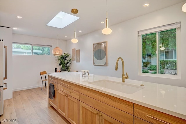 3022 El Camino Ave, Las Vegas, NV 89102 - kitchen with a skylight, light wood-style floors, decorative light fixtures, light countertops, and recessed lighting