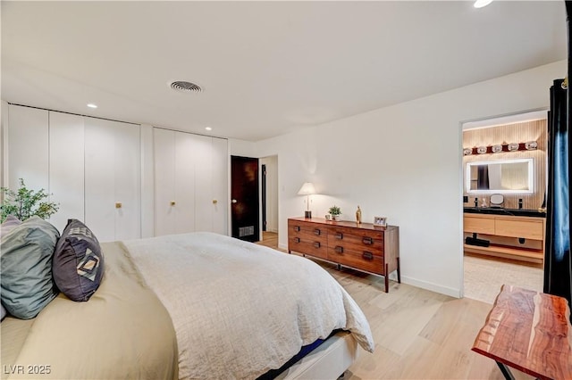 3022 El Camino Ave, Las Vegas, NV 89102 - bedroom with light wood-style flooring, multiple closets, recessed lighting, and ensuite bath