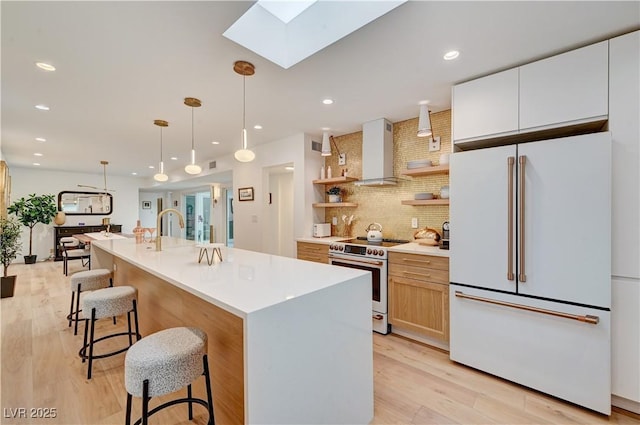 3022 El Camino Ave, Las Vegas, NV 89102 - kitchen featuring freestanding refrigerator, wall chimney range hood, electric range, a skylight, and open shelves