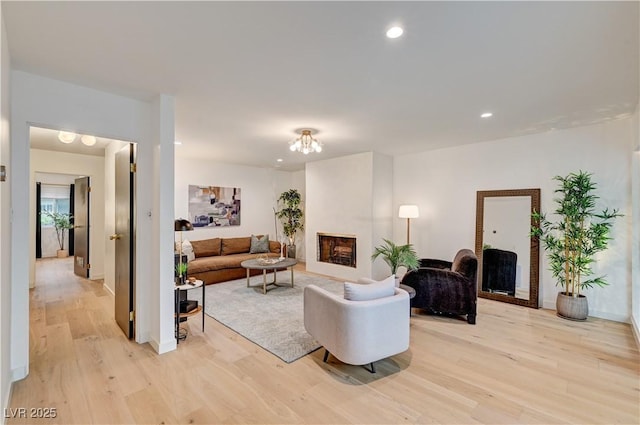 3022 El Camino Ave, Las Vegas, NV 89102 - living room with light wood-type flooring, a fireplace, recessed lighting, and a chandelier
