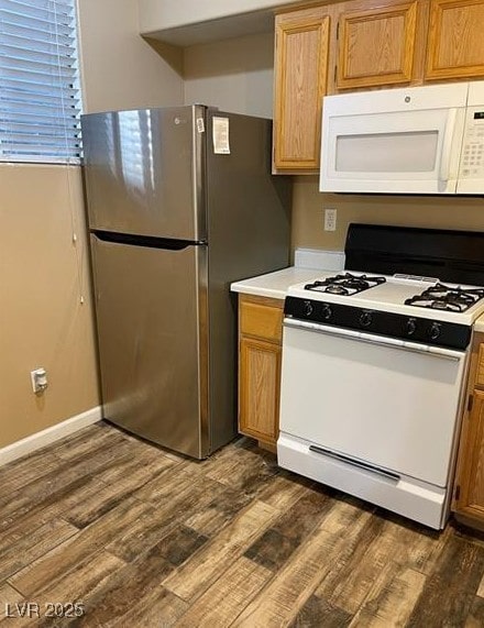 9050 W Warm Springs Rd Unit 1128, Las Vegas, NV 89148 - kitchen with white appliances, dark wood-style flooring, and light countertops