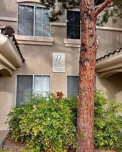 9050 W Warm Springs Rd Unit 1128, Las Vegas, NV 89148 - doorway to property featuring stucco siding