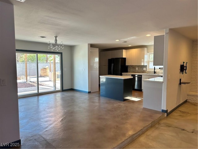1518 Golden Arrow Dr, Las Vegas, NV 89169 - kitchen with freestanding refrigerator, dishwasher, a kitchen island, light countertops, and plenty of natural light