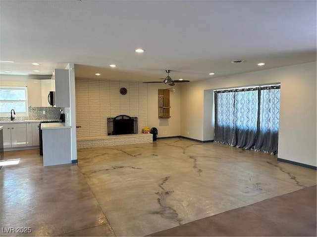 1518 Golden Arrow Dr, Las Vegas, NV 89169 - unfurnished living room with concrete floors, recessed lighting, a ceiling fan, and a brick fireplace