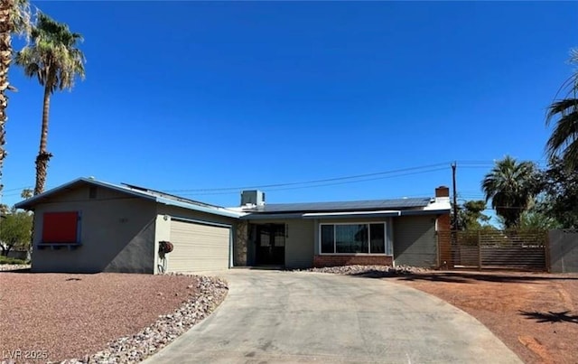 1518 Golden Arrow Dr, Las Vegas, NV 89169 - ranch-style home with a garage, roof mounted solar panels, concrete driveway, and brick siding