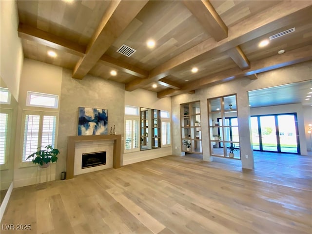 3012 Hawksdale Dr, Las Vegas, NV 89134 - unfurnished living room featuring french doors, a fireplace, beamed ceiling, wood finished floors, and recessed lighting