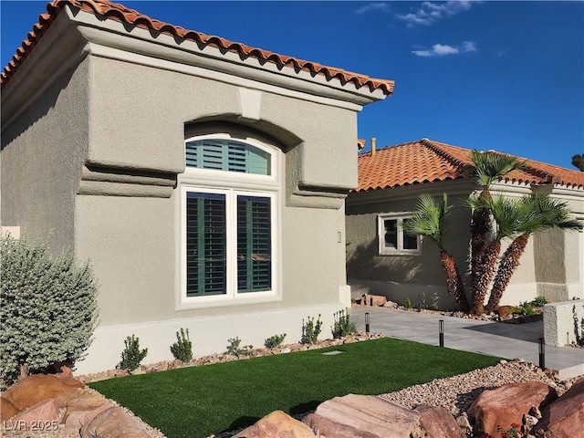3012 Hawksdale Dr, Las Vegas, NV 89134 - view of front of property with a tile roof, stucco siding, and a front yard