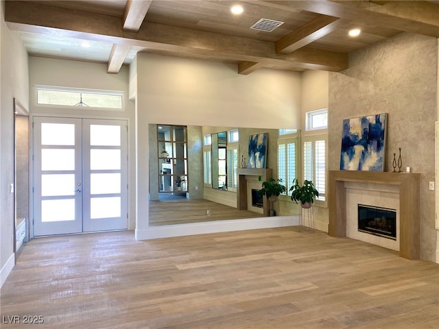 3012 Hawksdale Dr, Las Vegas, NV 89134 - entrance foyer with a glass covered fireplace, beamed ceiling, wood finished floors, french doors, and a high ceiling