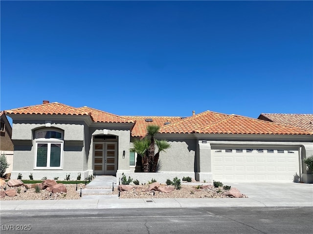 3012 Hawksdale Dr, Las Vegas, NV 89134 - mediterranean / spanish-style home featuring stucco siding, a garage, concrete driveway, and a tiled roof
