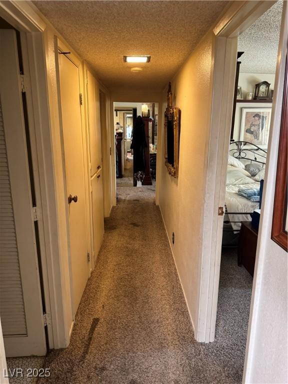 3708 Heritage Ave, Las Vegas, NV 89121 - hallway with carpet and a textured ceiling