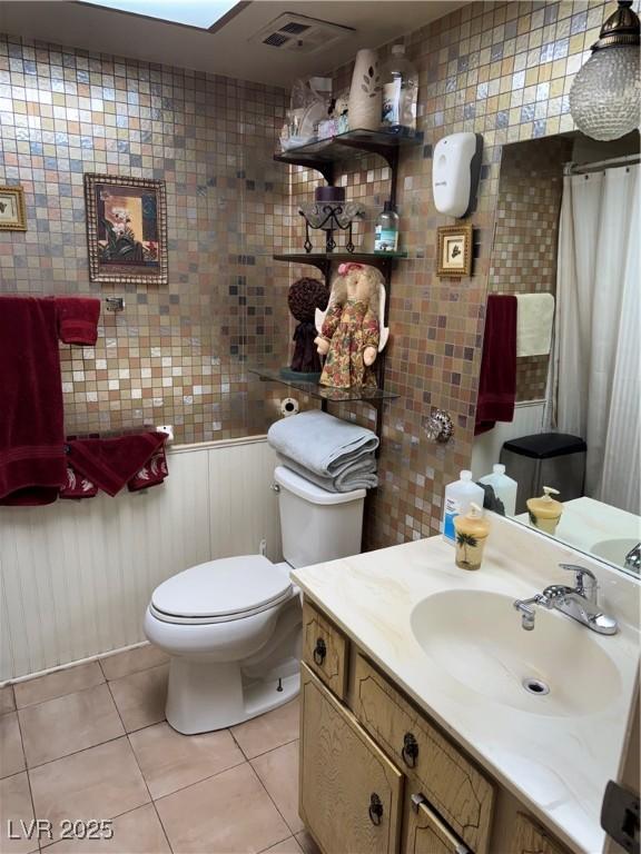 3708 Heritage Ave, Las Vegas, NV 89121 - bathroom featuring tile patterned flooring, vanity, and tile walls
