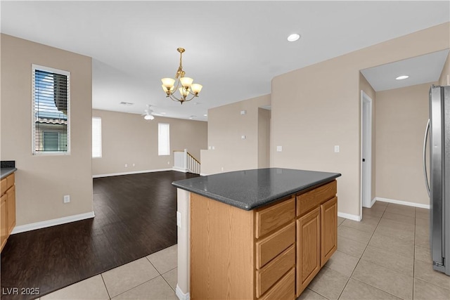 9489 Country Highlands Ct, Las Vegas, NV 89178 - kitchen featuring freestanding refrigerator, a chandelier, light tile patterned floors, dark countertops, and recessed lighting
