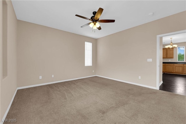 9489 Country Highlands Ct, Las Vegas, NV 89178 - empty room featuring dark colored carpet, a chandelier, ceiling fan, and a smoke detector