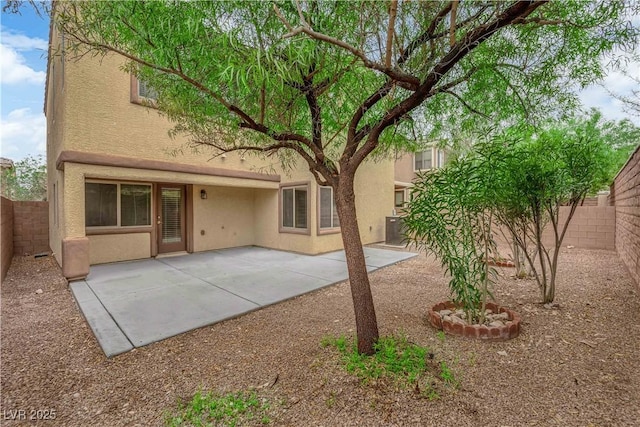9489 Country Highlands Ct, Las Vegas, NV 89178 - back of property featuring stucco siding, a fenced backyard, and a patio area