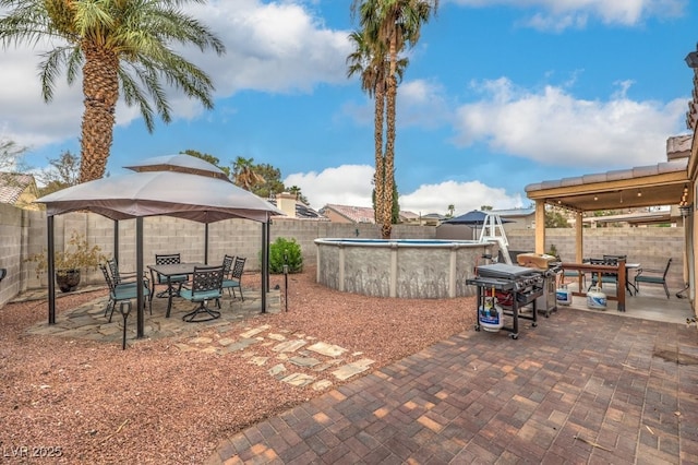 4006 Clove Tree Ct, North Las Vegas, NV 89031 - fenced backyard with a gazebo, outdoor dining space, and a patio