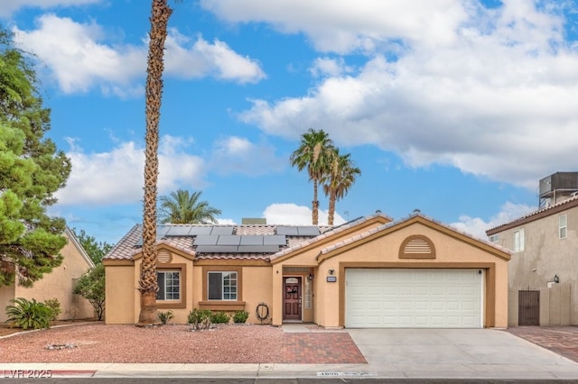4006 Clove Tree Ct, North Las Vegas, NV 89031 - mediterranean / spanish home featuring a tiled roof, stucco siding, concrete driveway, a garage, and roof mounted solar panels