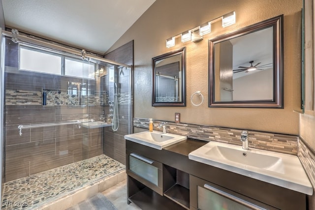 4006 Clove Tree Ct, North Las Vegas, NV 89031 - full bathroom featuring vaulted ceiling, a shower stall, double vanity, a ceiling fan, and backsplash