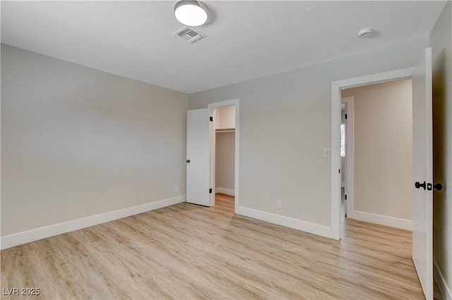4512 Mark Ave, Las Vegas, NV 89108 - unfurnished bedroom featuring light wood-style flooring, a walk in closet, and a closet