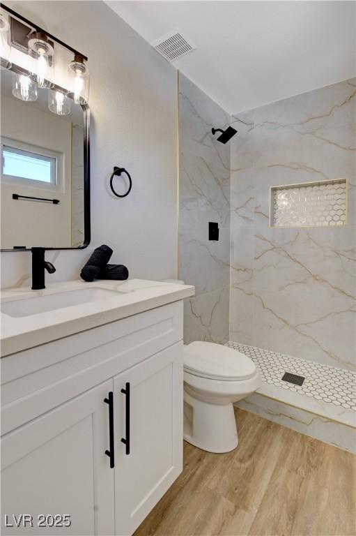 4512 Mark Ave, Las Vegas, NV 89108 - full bathroom with vanity, wood finished floors, and a marble finish shower