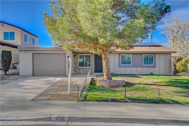 4512 Mark Ave, Las Vegas, NV 89108 - view of front of property with board and batten siding, solar panels, concrete driveway, a front yard, and a garage