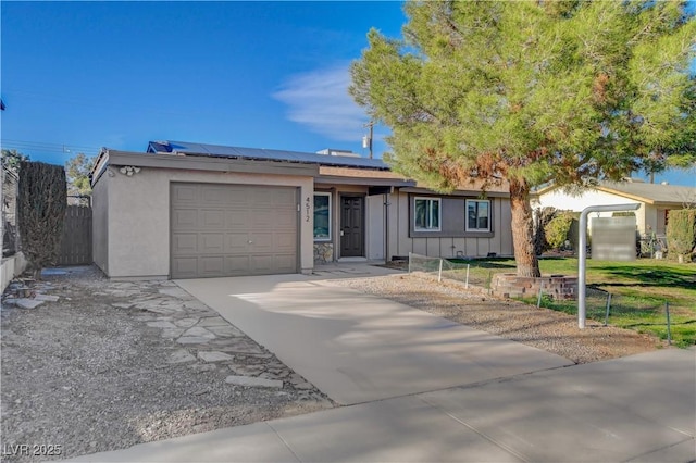 4512 Mark Ave, Las Vegas, NV 89108 - single story home featuring a garage, board and batten siding, driveway, and solar panels