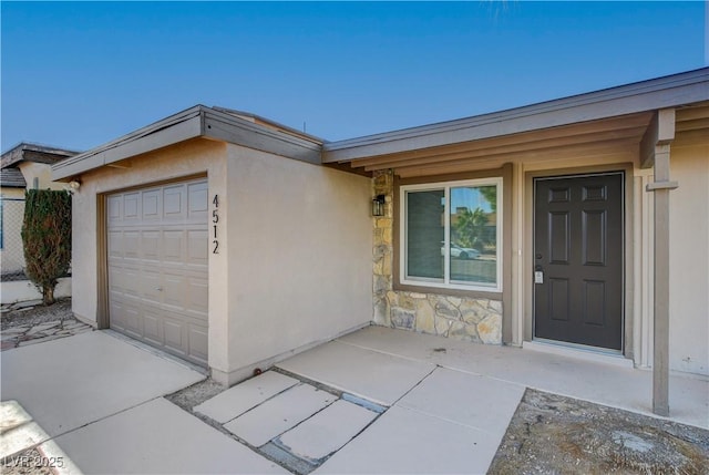 4512 Mark Ave, Las Vegas, NV 89108 - property entrance featuring stone siding, stucco siding, and an attached garage