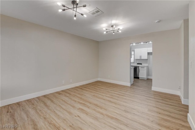 4512 Mark Ave, Las Vegas, NV 89108 - unfurnished room with a chandelier, light wood finished floors, and a smoke detector