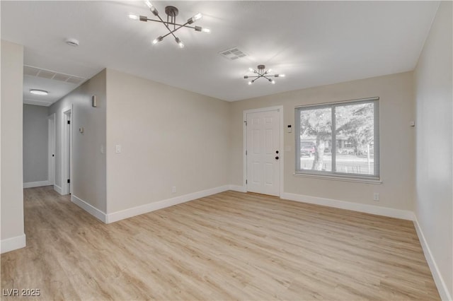4512 Mark Ave, Las Vegas, NV 89108 - unfurnished living room featuring a chandelier and light wood finished floors