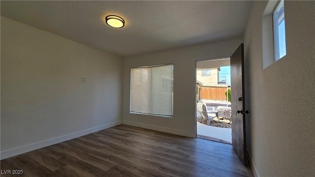 4512 Mark Ave, Las Vegas, NV 89108 - unfurnished room featuring dark wood finished floors, plenty of natural light, and a textured wall